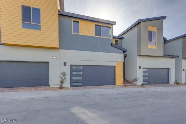 modern home with an attached garage and stucco siding