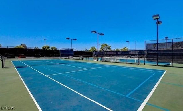 view of sport court featuring fence