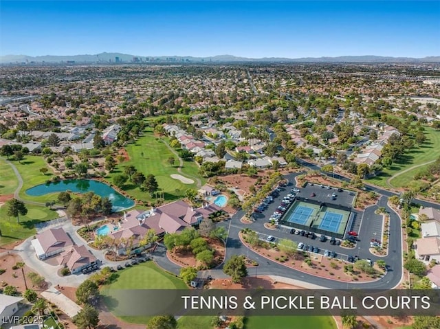 aerial view featuring a residential view, golf course view, and a water and mountain view