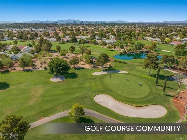 birds eye view of property with golf course view and a water and mountain view