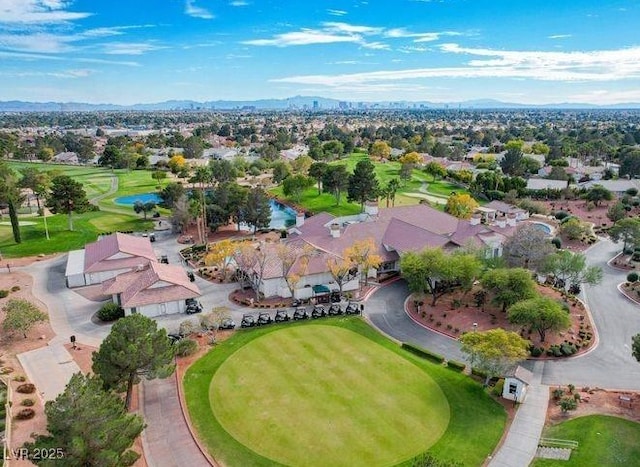 drone / aerial view with view of golf course and a residential view