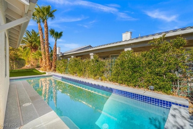 view of pool with a fenced in pool and fence