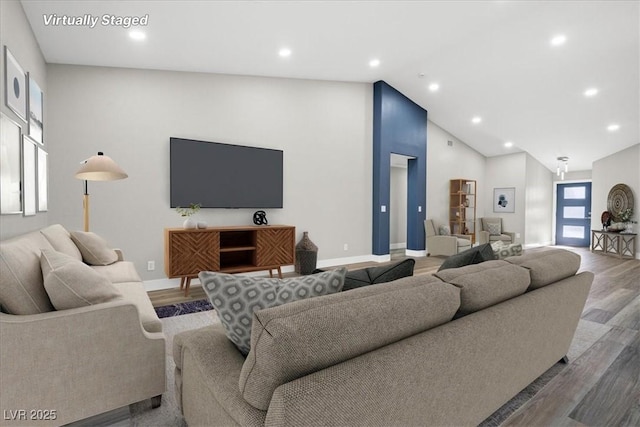 living room with high vaulted ceiling, recessed lighting, wood finished floors, and baseboards