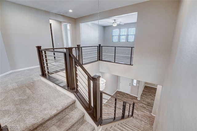 staircase featuring carpet floors and baseboards