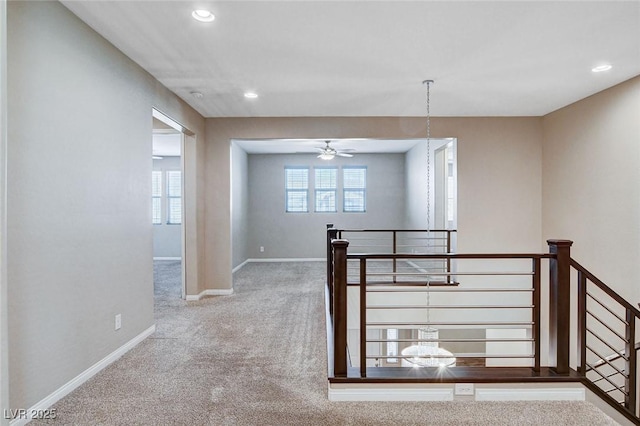 interior space featuring recessed lighting, carpet, an upstairs landing, and baseboards