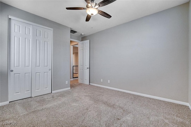 unfurnished bedroom featuring a closet, visible vents, carpet flooring, ceiling fan, and baseboards