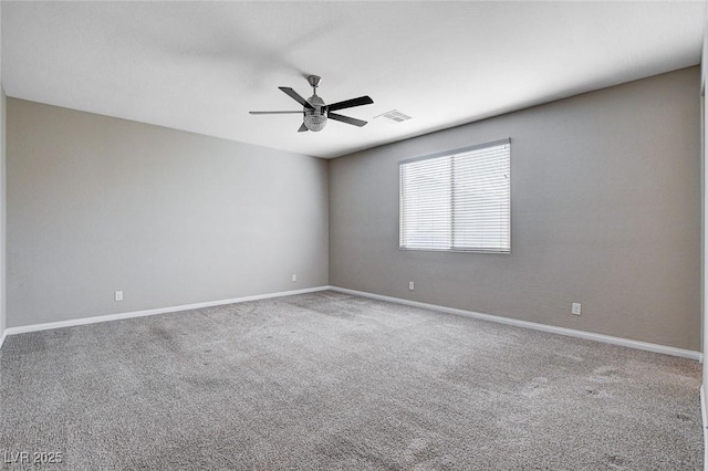 carpeted empty room with ceiling fan, visible vents, and baseboards