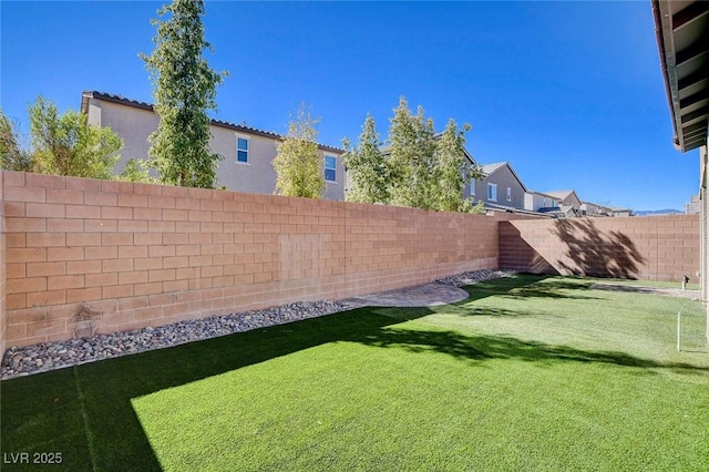 view of yard with a fenced backyard