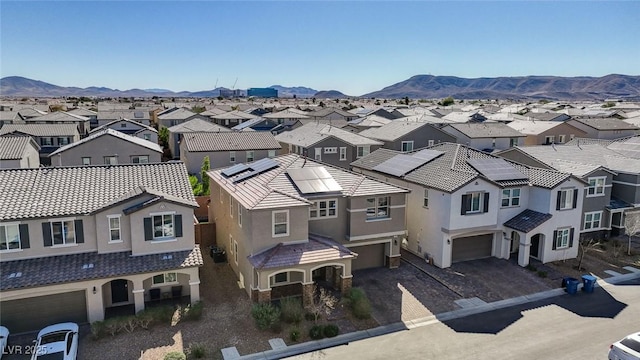 drone / aerial view featuring a residential view and a mountain view