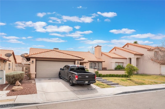 mediterranean / spanish-style house featuring a garage, concrete driveway, a tile roof, a chimney, and stucco siding