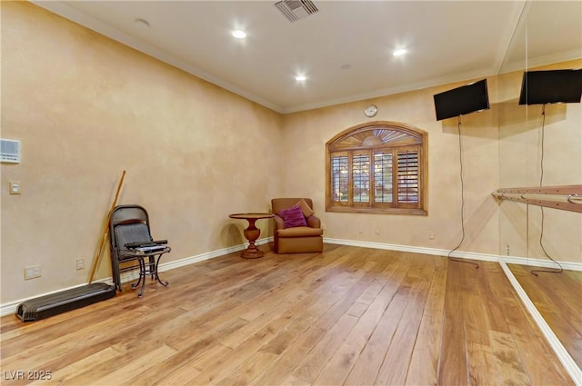 unfurnished room with crown molding, recessed lighting, visible vents, baseboards, and hardwood / wood-style flooring