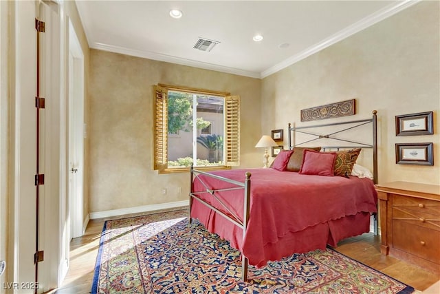 bedroom with baseboards, light wood-type flooring, visible vents, and crown molding