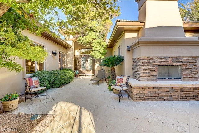 view of patio with an outdoor stone fireplace