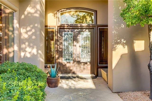 property entrance featuring french doors and stucco siding