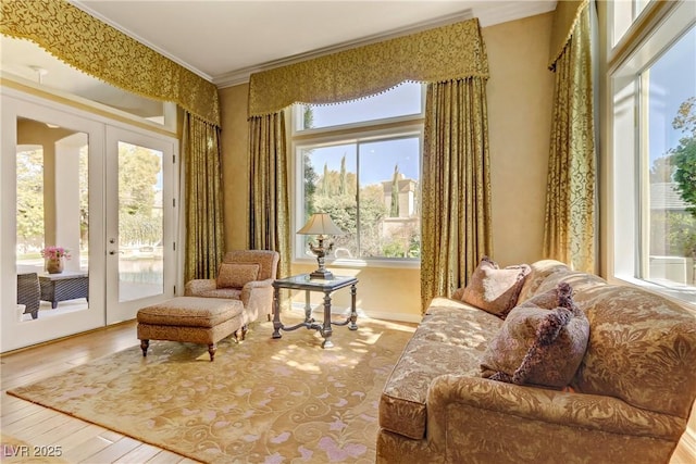 living area featuring french doors, crown molding, and wood-type flooring