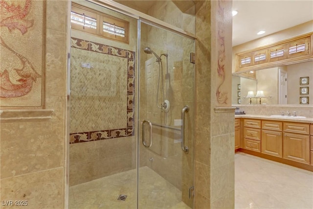 full bathroom featuring recessed lighting, a sink, a shower stall, and double vanity