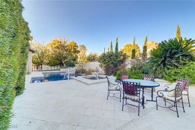 view of patio / terrace with a fenced in pool, outdoor dining area, and a fenced backyard