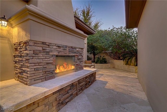 view of patio / terrace with an outdoor stone fireplace