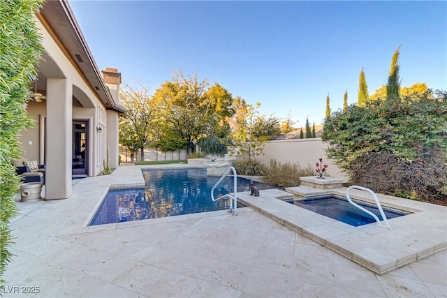 view of swimming pool with a fenced backyard, a patio, and an in ground hot tub