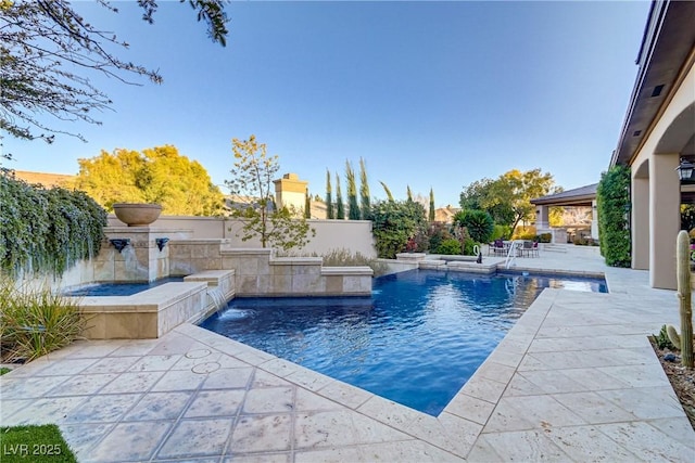 outdoor pool with a patio area and fence