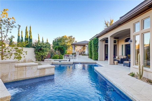 outdoor pool featuring a patio, outdoor lounge area, and fence