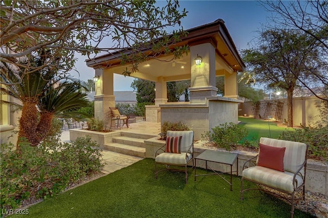 view of patio featuring fence and a gazebo