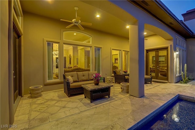 view of patio / terrace featuring ceiling fan, an outdoor living space, and french doors