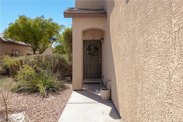 property entrance with stucco siding