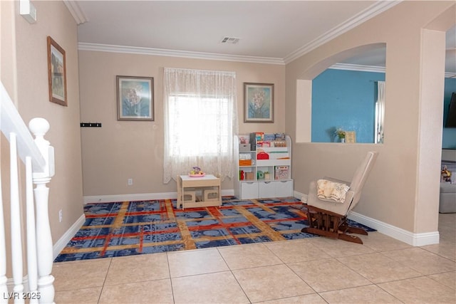 recreation room featuring arched walkways, crown molding, and tile patterned floors