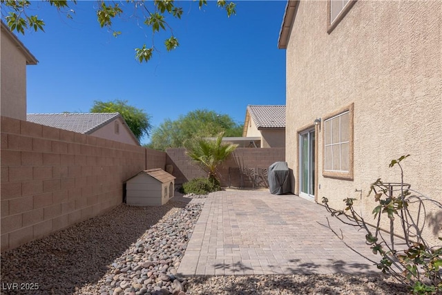 view of patio / terrace featuring a fenced backyard and a grill