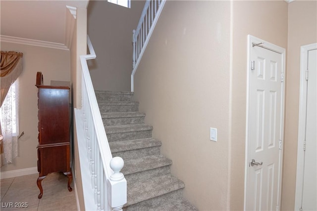 stairs featuring ornamental molding, tile patterned flooring, and baseboards