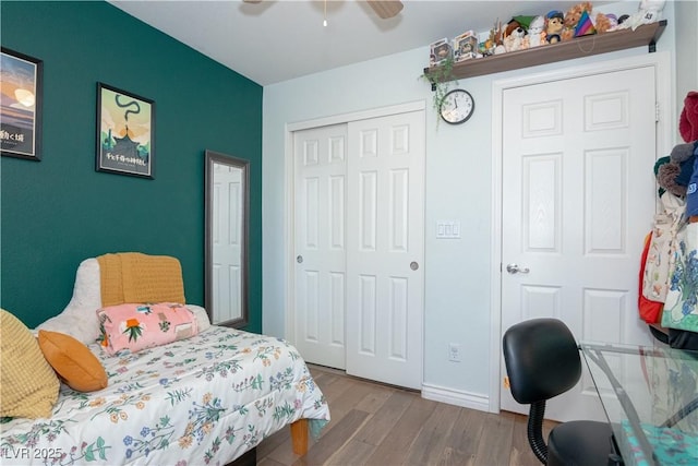 bedroom featuring baseboards, a ceiling fan, a closet, and wood finished floors