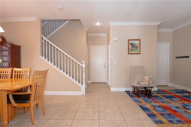 foyer entrance with stairs, crown molding, baseboards, and tile patterned floors