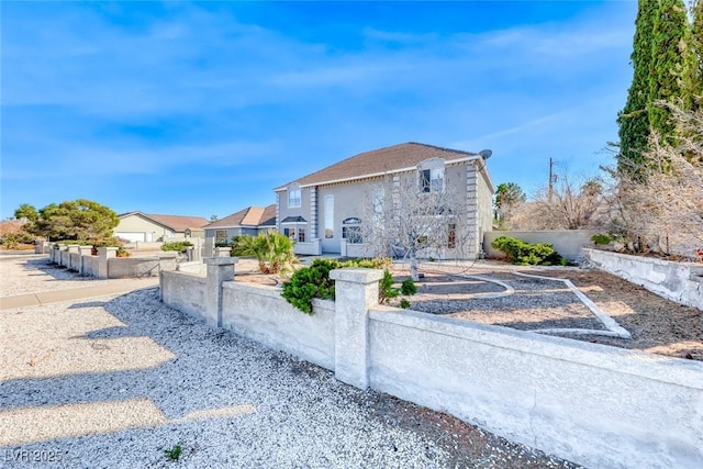 view of front of property featuring fence