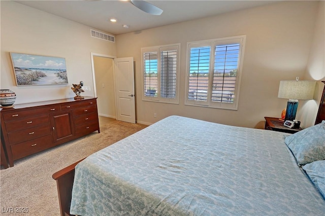 bedroom with light colored carpet, visible vents, baseboards, and a ceiling fan