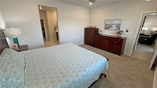 bedroom with baseboards and light carpet