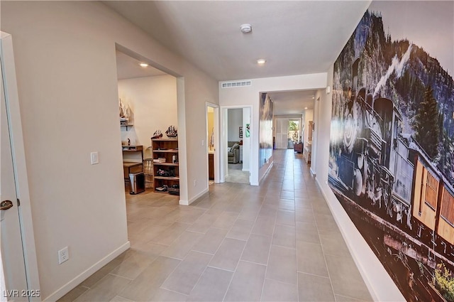 hall featuring visible vents and baseboards