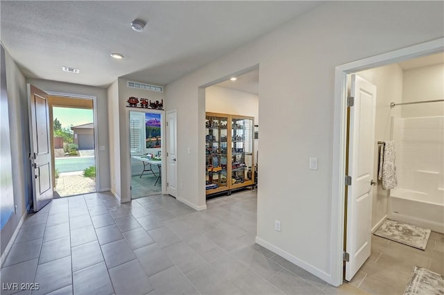 entrance foyer featuring baseboards and light tile patterned floors