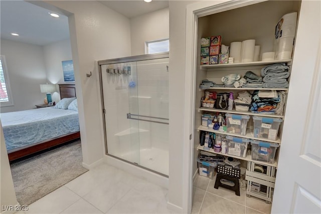 full bath with ensuite bathroom, a shower stall, baseboards, recessed lighting, and tile patterned flooring