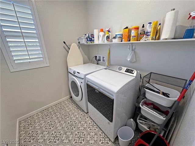 clothes washing area featuring laundry area, baseboards, washer and dryer, and light tile patterned flooring