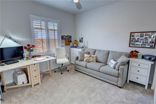 carpeted home office with a ceiling fan