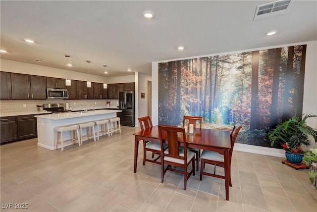 dining area featuring baseboards, visible vents, and recessed lighting