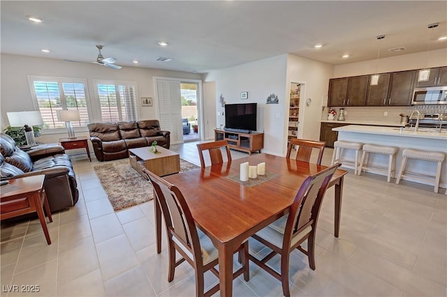 dining space featuring recessed lighting, a wealth of natural light, and light tile patterned flooring