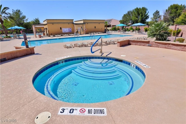 community pool with fence and a patio area