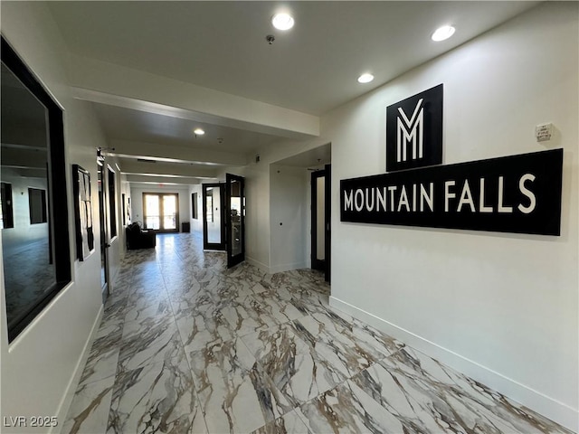 hall featuring recessed lighting, marble finish floor, and baseboards