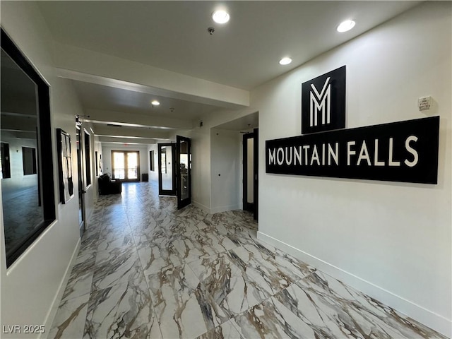 hallway with marble finish floor, baseboards, and recessed lighting