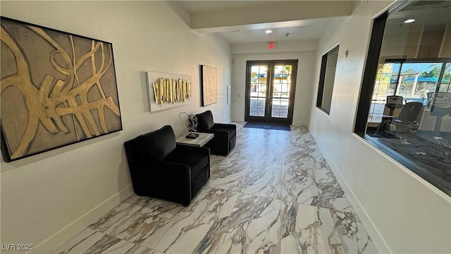 interior space featuring french doors, marble finish floor, and baseboards