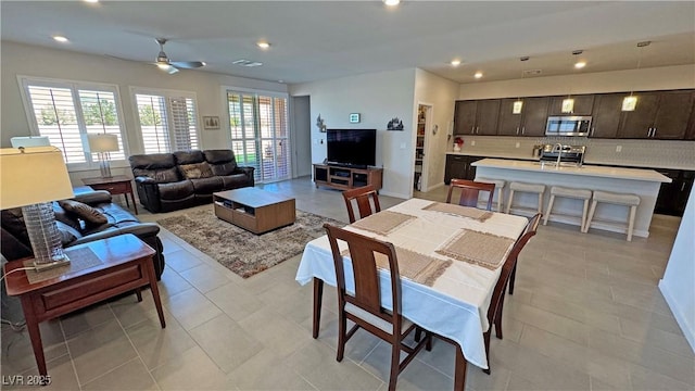 living room featuring ceiling fan, visible vents, recessed lighting, and light tile patterned floors