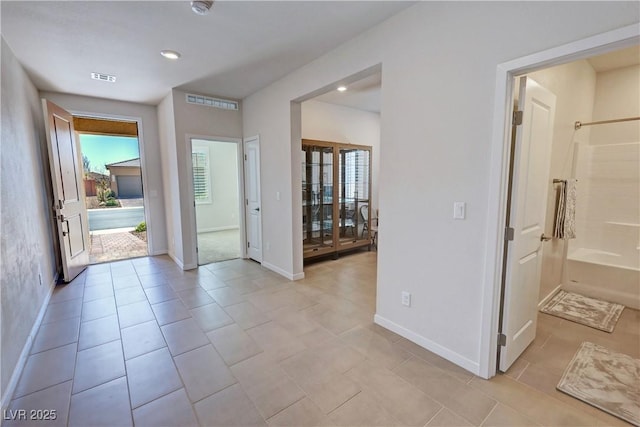 entrance foyer featuring light tile patterned flooring, baseboards, visible vents, and recessed lighting