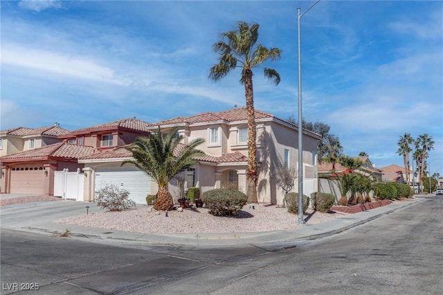 view of front of property with concrete driveway, a residential view, a tiled roof, an attached garage, and stucco siding